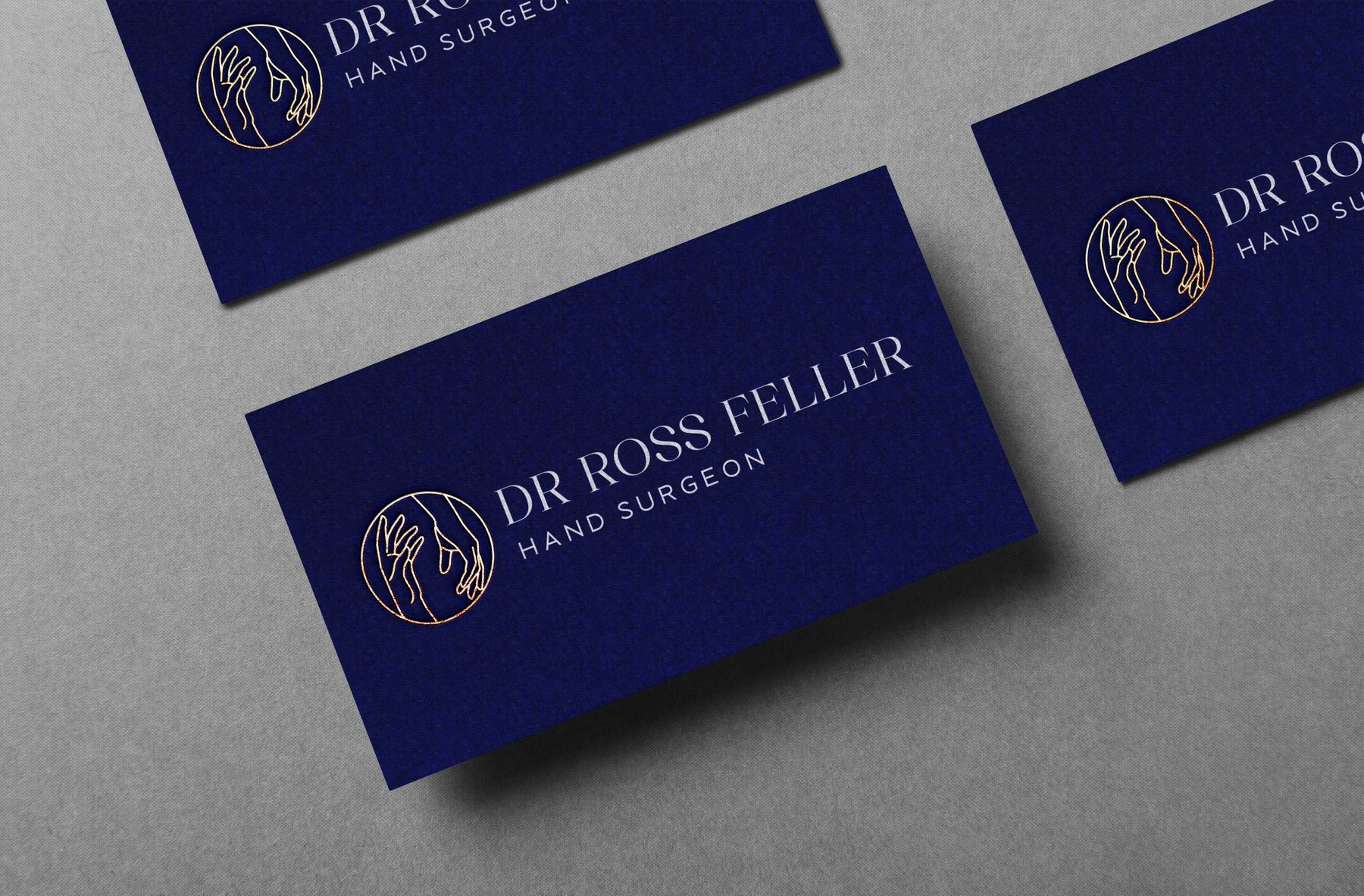 Navy Dr Ross Feller business cards on grey stone